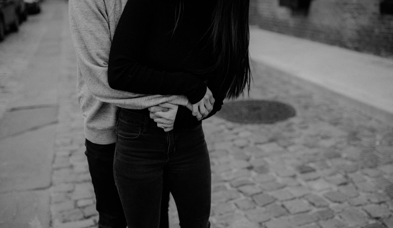 David wrapping his arms around Helen's waist, in black and white.