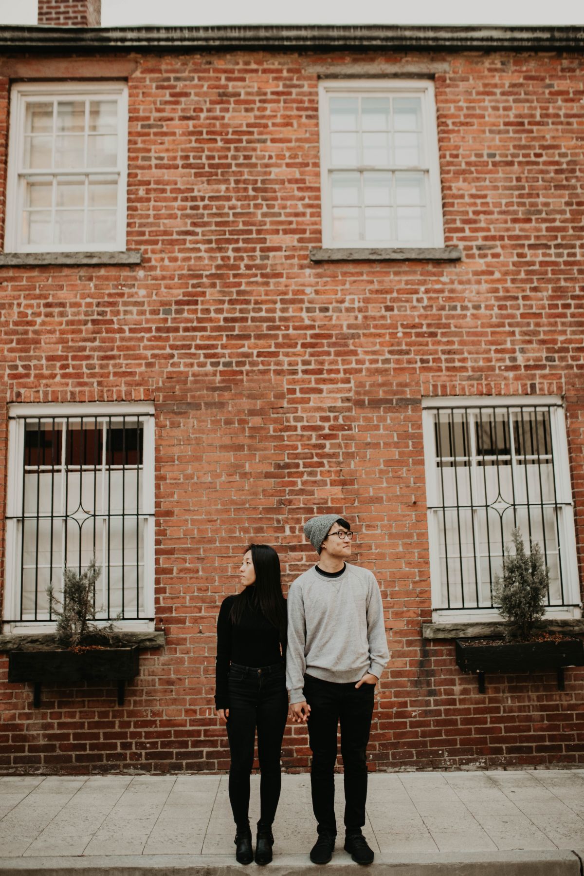 Nonchalantly looking away from each other.